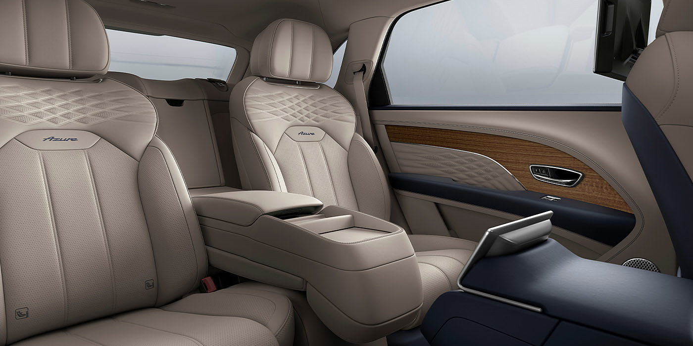 Bentley Hyderabad Bentley Bentayga EWB Azure interior view for rear passengers with Portland hide featuring Azure Emblem in Imperial Blue contrast stitch.