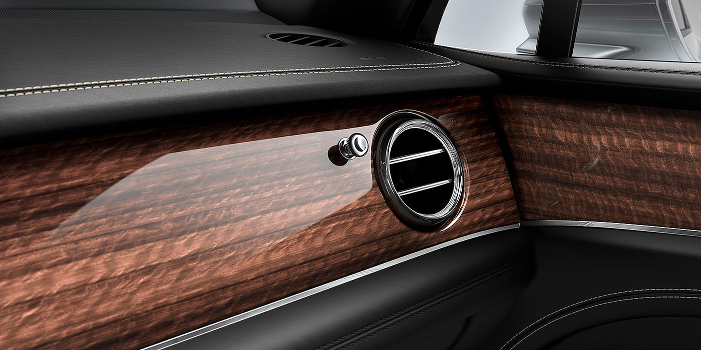 Bentley Hyderabad Bentley Bentayga front interior Crown Cut Walnut veneer and chrome air vent.